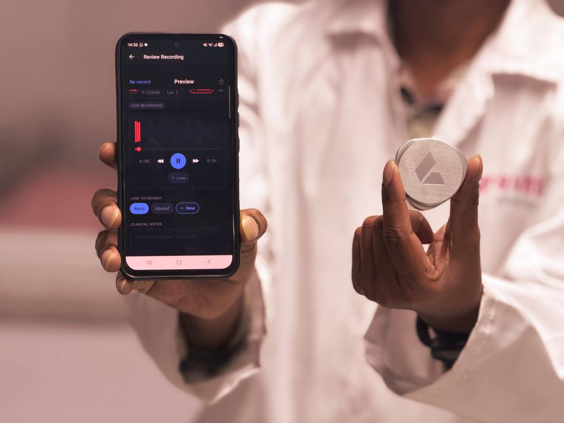 A clinician holding the Plazma auscultation device beside a phone showing a live recording.